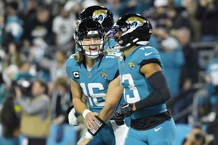Trevor Lawrence yells in celebration with teammate wide receiver Christian Kirk